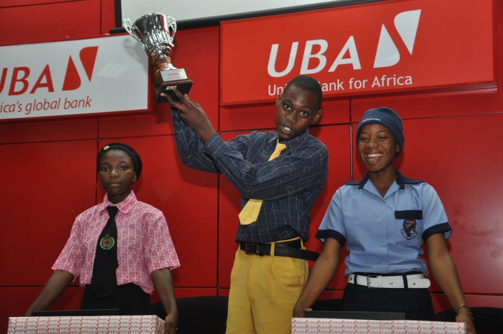  Deputy Managing Director, UBA Plc, Mr. Kennedy Uzoka; 1ST Prize Winner, Master Ezenwa Joseph Okonkwo, student of Ambol Comprehensive High School, Akesan-Igando, Lagos (Middle); and President, Institute of Chartered Accountant of Nigeria (ICAN), Alhaji Alkali Mohammed, at the grand finale ceremony of UBA Foundation National Essay Competition for Secondary School Students held at UBA House, in Lagos on Monday